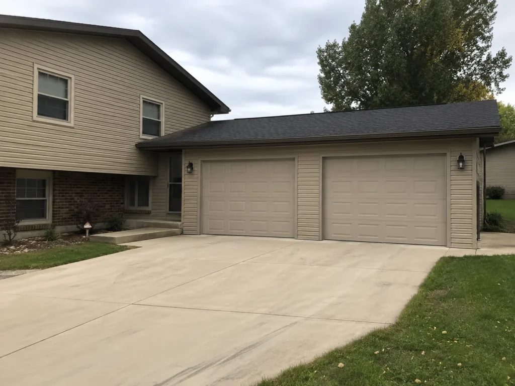 Completed two-car detached garage with concrete driveway in Cedar Rapids, Iowa.