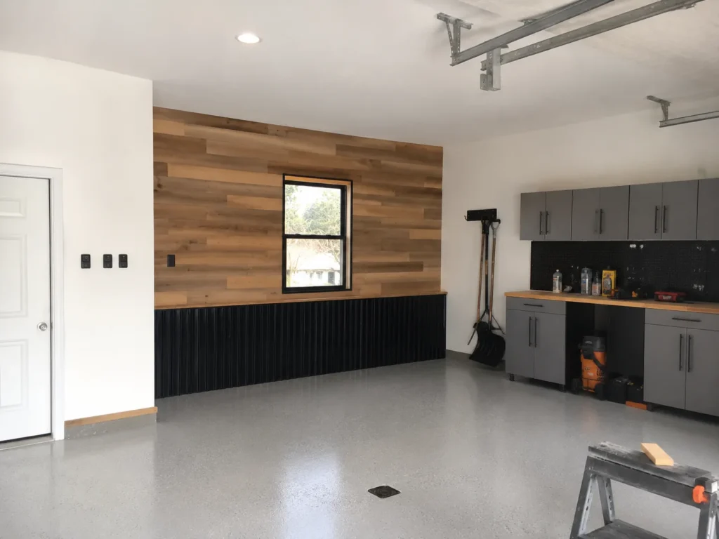 Finished garage interior with cabinets and epoxy floor in Cedar Rapids, Iowa.