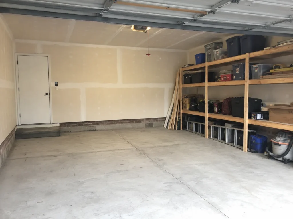 Finished garage interior with drywall and storage shelving in Cedar Rapids, Iowa.