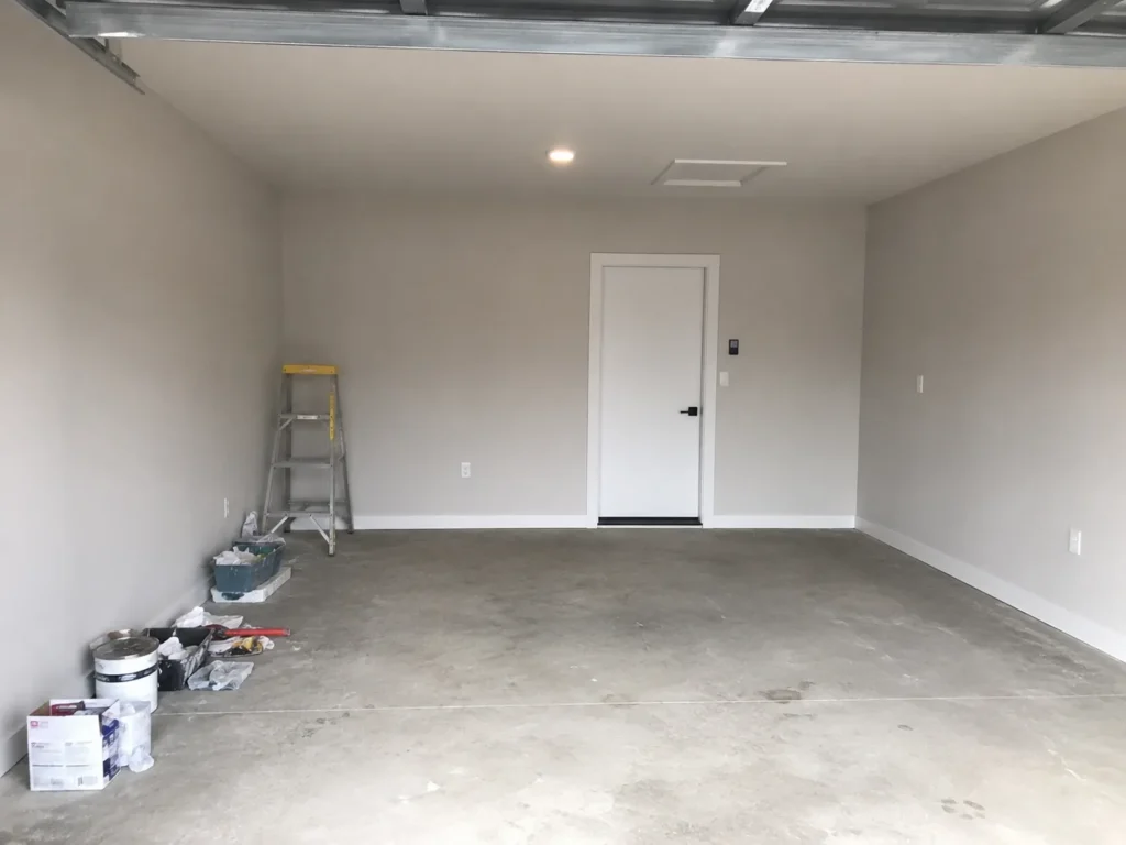 Finished garage interior with white walls and concrete floor in Cedar Rapids, Iowa.