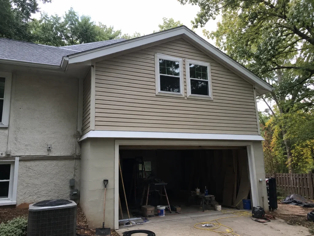 Two-story garage addition exterior with open bay in Cedar Rapids, Iowa.