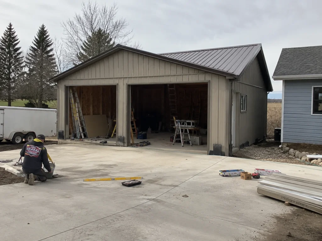 Detached garage exterior finishing with metal roof in Robins, Iowa.